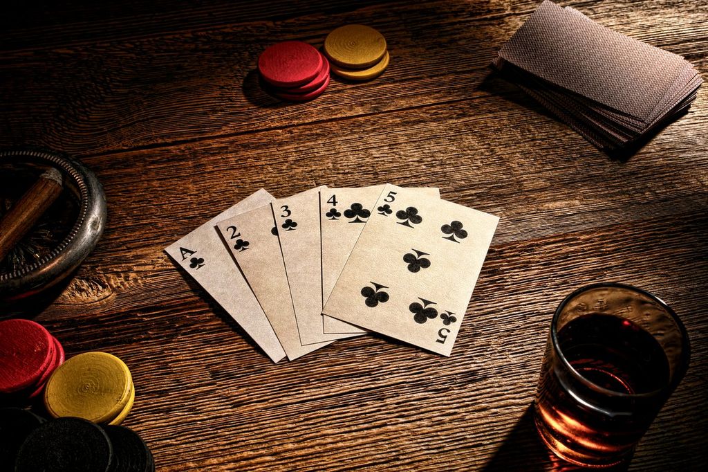 A classic hand of aces with chips and a cigar on a card table.