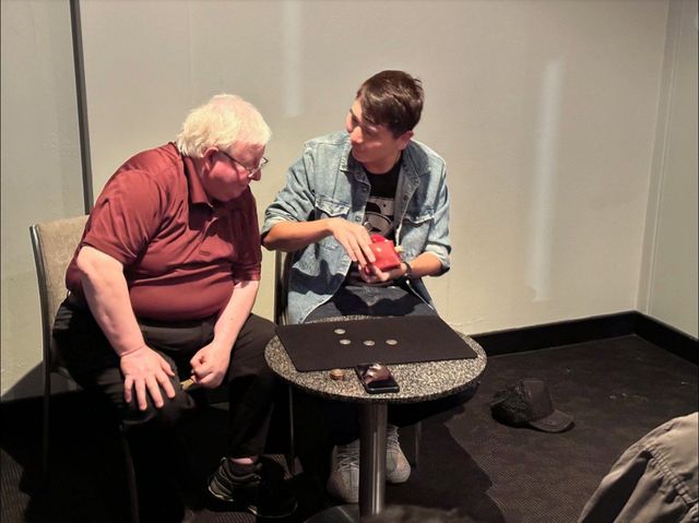 Coin magic shared at a table at the October 2023 meeting