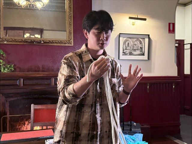 A member performs a rope routine in the Le Roi room