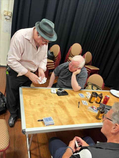 Card magic at a table during the May 2024 meeting at the Blue Room Theatre