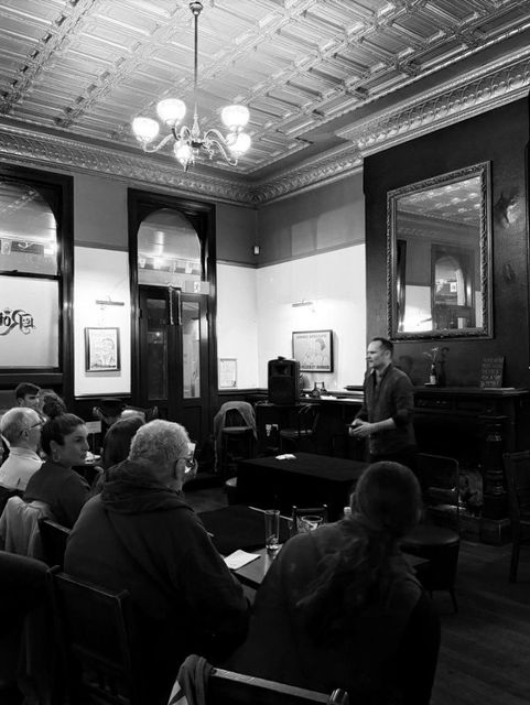 A member addresses the audience at WASM's first open meeting in the Le Roi room ("Got there late, but had a great night")